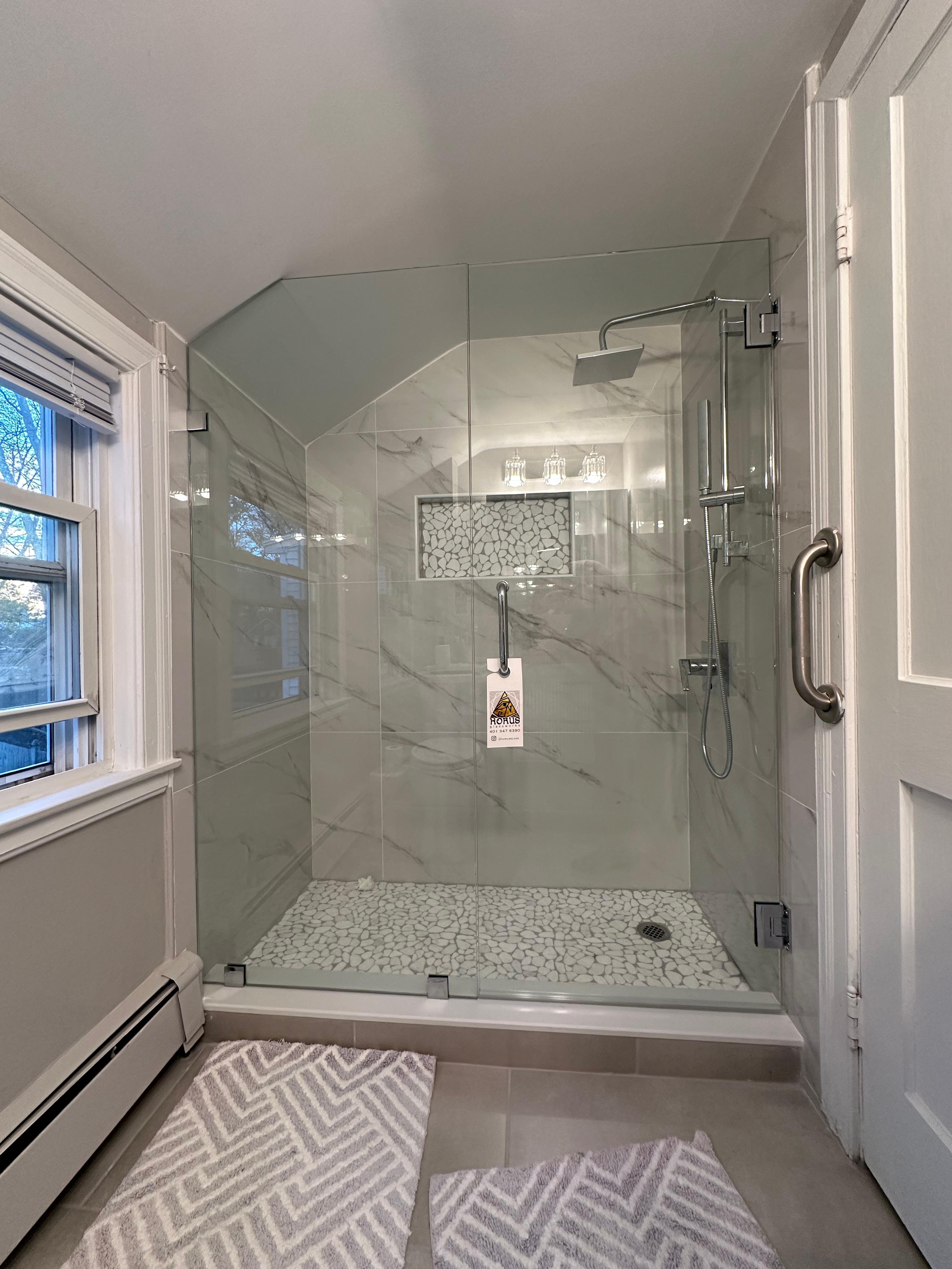 Horus Glassworks frameless shower enclosure beside a bathroom window